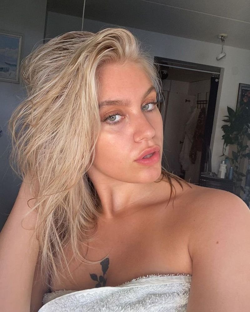 reserved blonde woman looks at camera  sugarcoupling.com